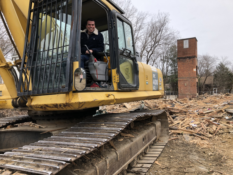 Gardner, Massachusetts Rock St Demo showing a man in a excavator