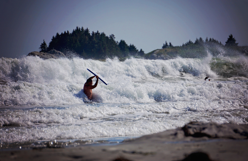 Shelburne, Nova Scotia a person in the surf riding the waves